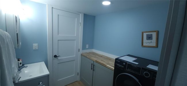 Laundry area featuring washer / clothes dryer, laundry area, a sink, and recessed lighting | Image 16