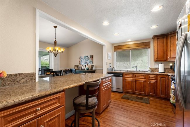 This kitchen has been opened up to the dining room area with a custom breakfast bar | Image 14