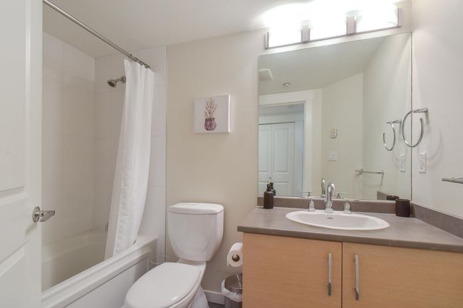 Bathroom featuring vanity and shower / bath combination with curtain | Image 9