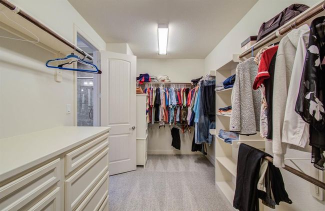 Primary closet has custom drawers and brand new carpet. | Image 35