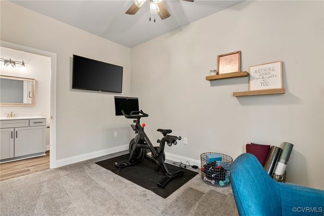 Workout area with ceiling fan, sink, and light carpet | Image 26