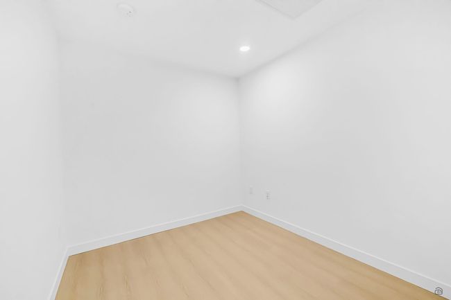 Empty room with light wood-style flooring, recessed lighting, and baseboards | Image 17