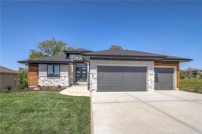 Prairie-style home with a front lawn and a garage | Image 1