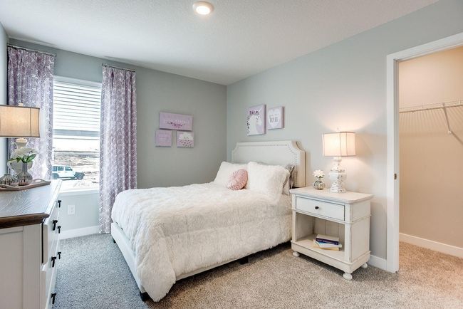 One of the 3 secondary bedrooms in the Finnegan. Each with walk-in closets! Photo of model home, colors and selections shown may vary | Image 12