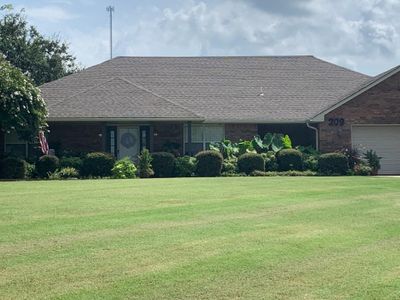 View of front of home with a garage and a front yard | Image 1