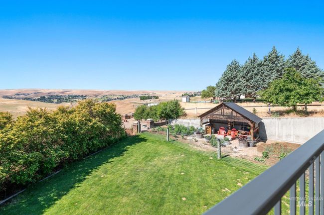 View of grassy yard featuring a patio & garden area | Image 45
