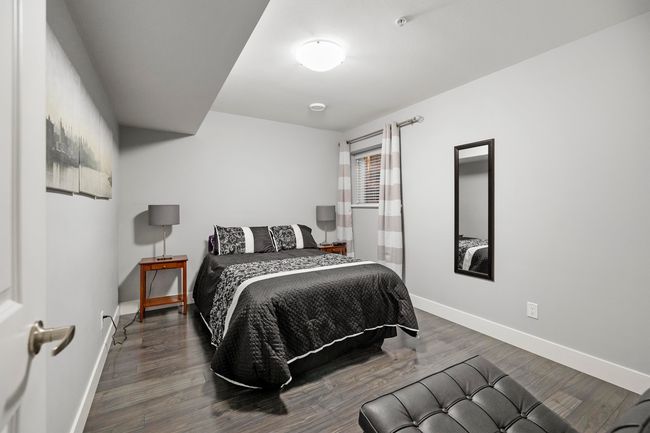 Bedroom with baseboards and wood finished floors | Image 33