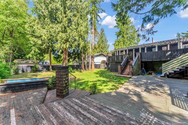 Wooden terrace with a yard, a fenced backyard, and stairs | Image 36