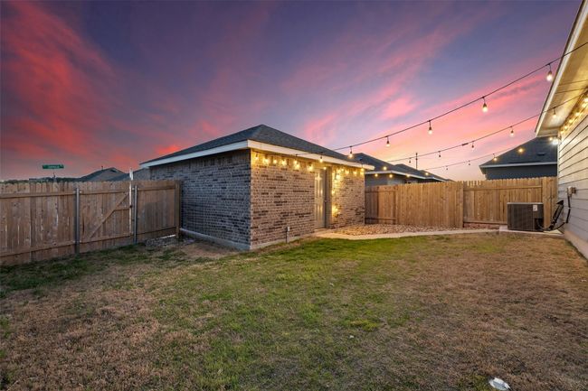 Yard at dusk featuring central air condition unit and a fenced backyard | Image 24