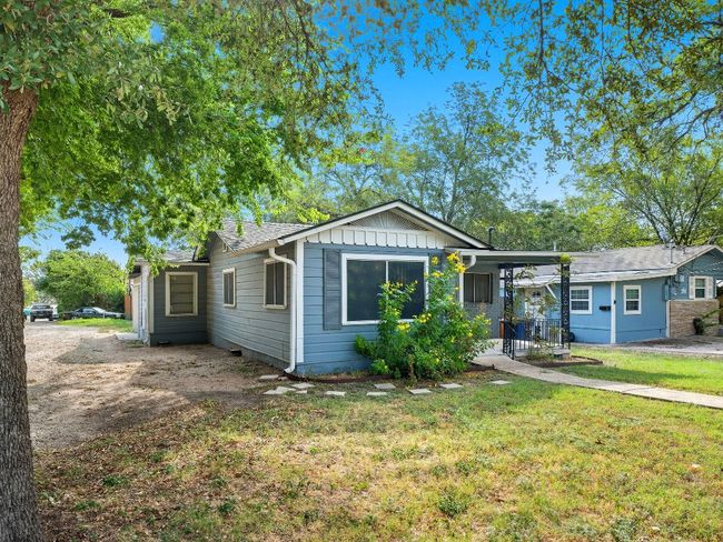 View of front of house with a front lawn and board and batten siding | Image 7
