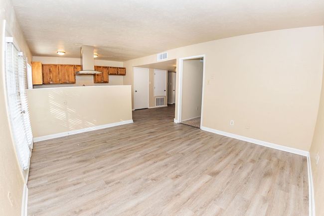 Unfurnished living room featuring light hardwood / wood-style floors | Image 19