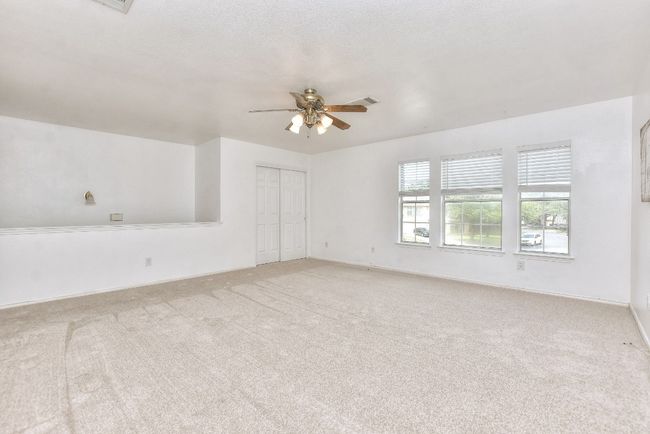 Another view of the upstairs bonus/game/flex space showing 1 set of closet doors. | Image 21