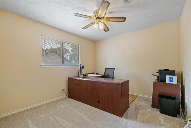 Bedroom #2 is spacious and bright with a ceiling fan and plenty of closet space. It's currently used as an office. | Image 31