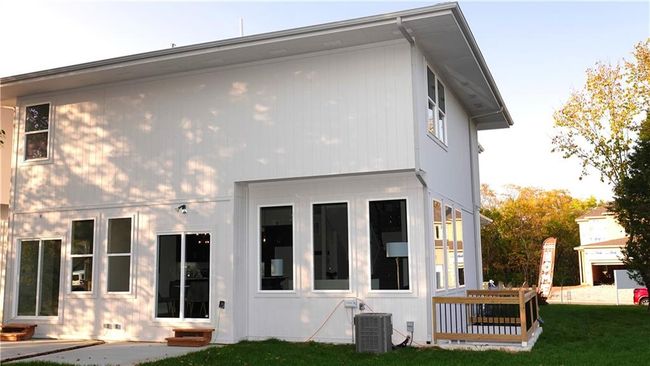 Back of property with entry steps, a yard, crawl space, and central air condition unit | Image 51