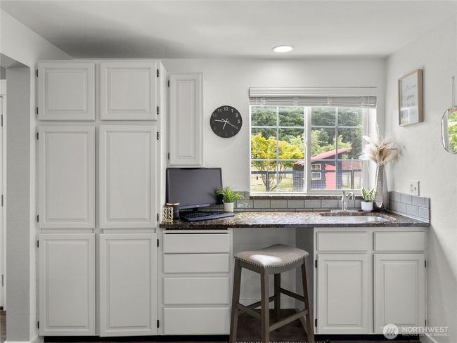Eating and wet bar with views of the garden. | Image 15