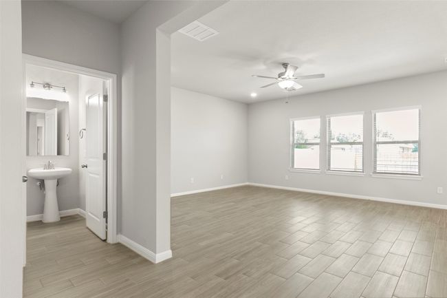 Unfurnished room with a ceiling fan, light wood-style flooring, and baseboards | Image 4