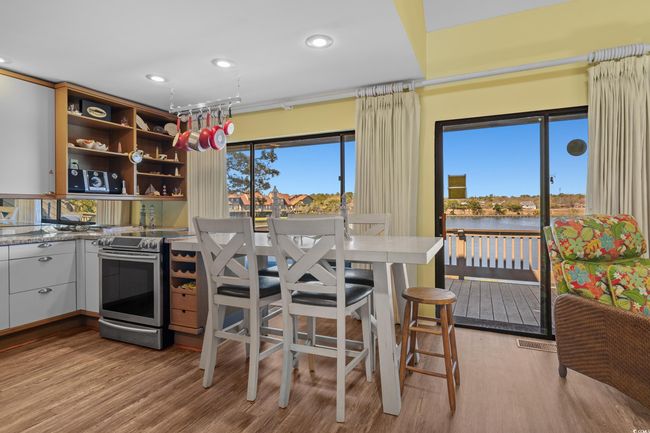 Kitchen featuring recessed lighting, open shelves, stainless steel electric range, and light wood-type flooring | Image 15