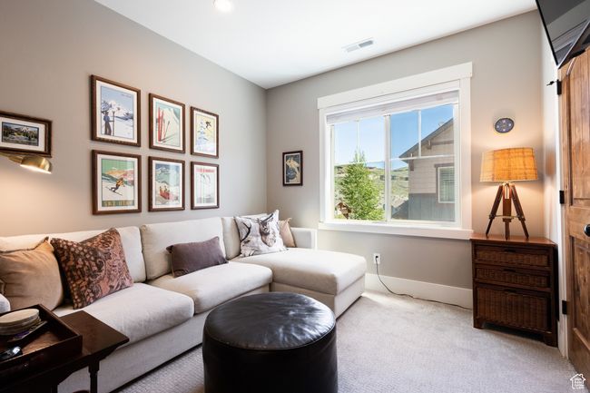 Living area featuring carpet floors, baseboards, and visible vents | Image 13