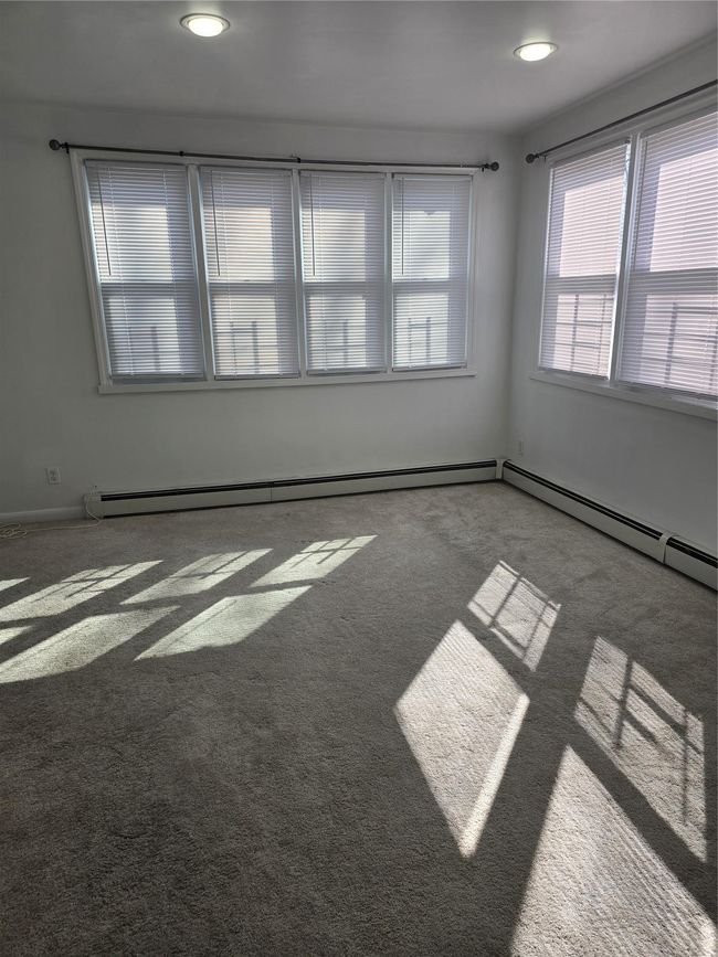 Spare room with carpet floors and baseboard heating | Image 15