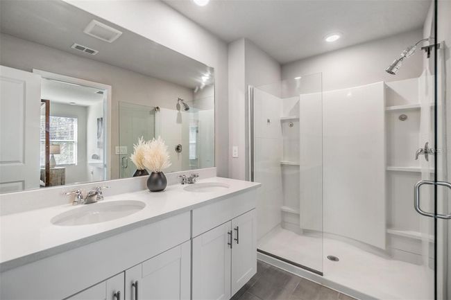 primary ensuite bathroom with dual vanities & newer glass door | Image 14