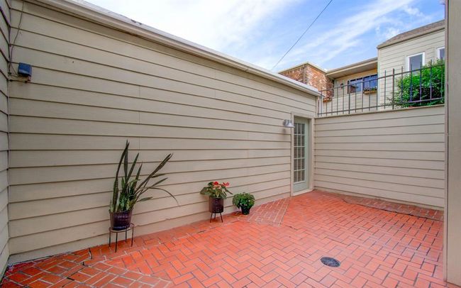 Charming private patio with brick flooring, ideal for outdoor relaxation and easy maintenance. | Image 21