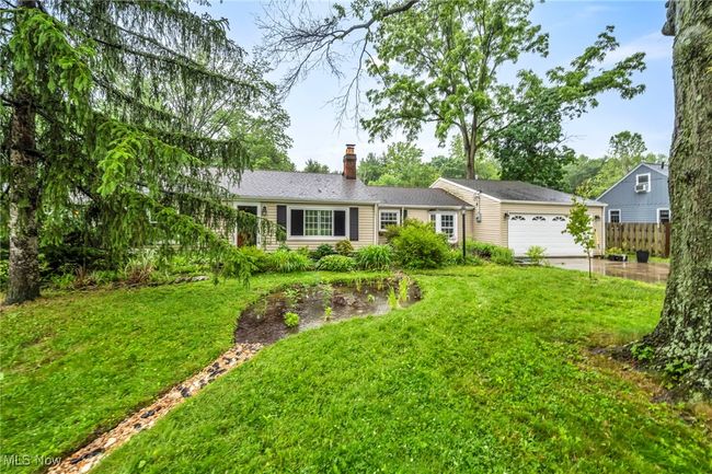 Ranch-style home with an attached garage, a chimney, and driveway | Image 33