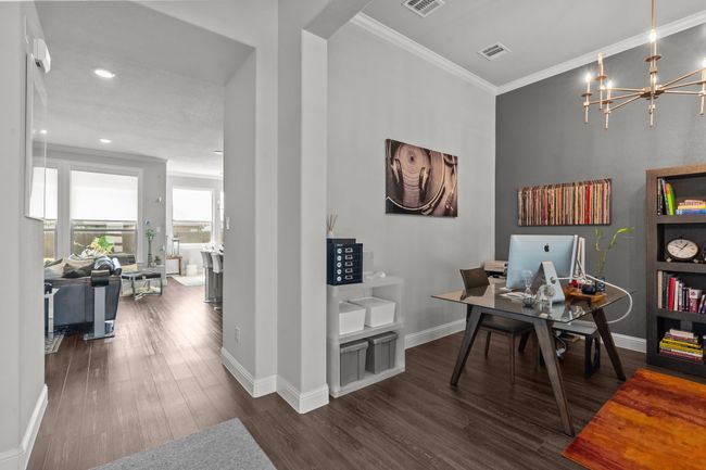 Office featuring crown molding, wood finished floors, a chandelier, and recessed lighting | Image 4