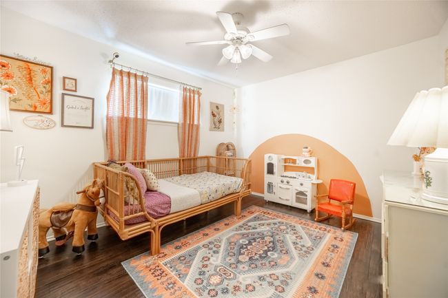Bedroom with wood finished floors, a ceiling fan, and baseboards | Image 15