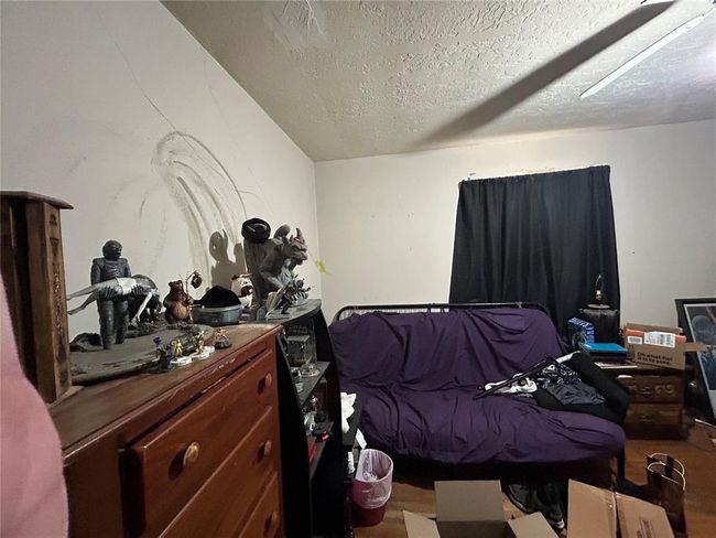 Unfurnished bedroom with light wood-type flooring, ceiling fan, baseboards, and a closet | Image 13