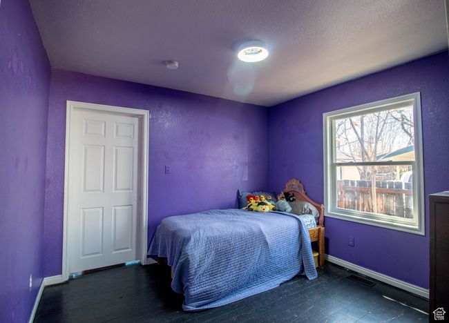 Bedroom with wood finished floors and baseboards | Image 16
