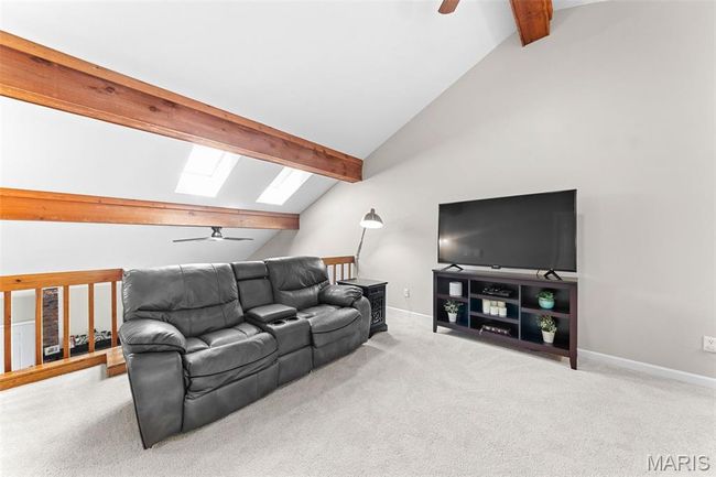 Loft area with vaulted ceilings, wet bar, new carpeting, and access to the massive deck over the garage. | Image 15