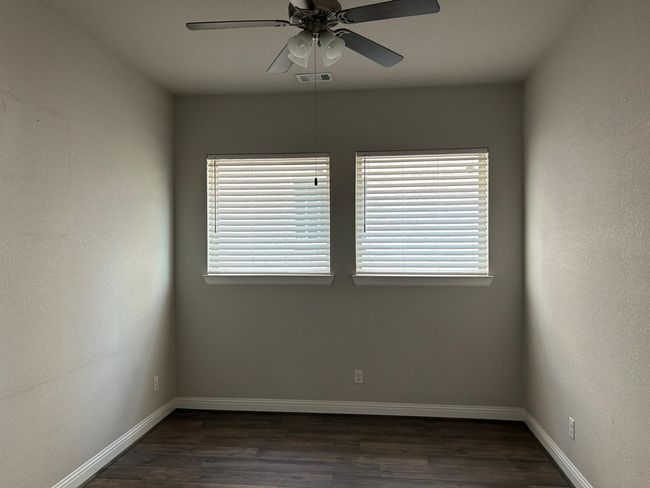 Office room with wood-style flooring, baseboards, and a ceiling fan | Image 9