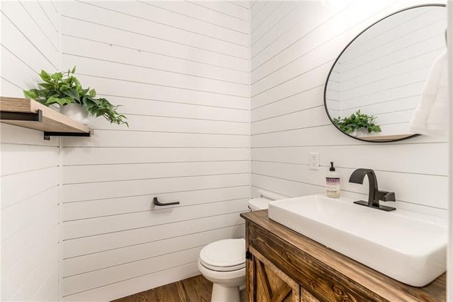 Bathroom with vanity, wood finished floors, and wooden walls | Image 19