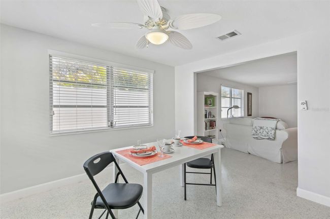 Another view of the dining room with the living room in the rear. | Image 10