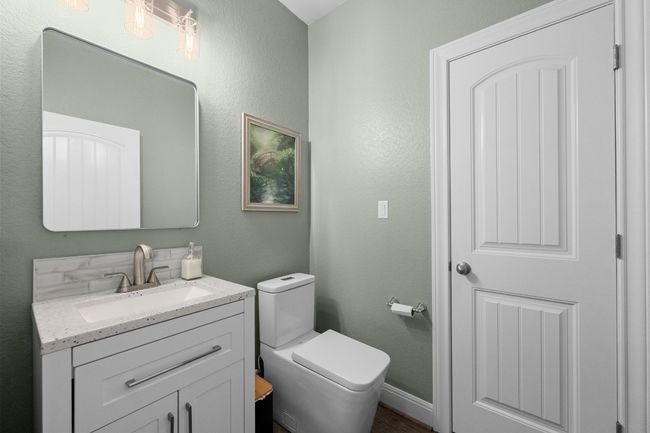 Half bath with vanity and wood finished floors | Image 32
