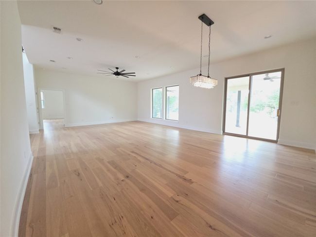 Spare room featuring light wood-style floors, a ceiling fan, and baseboards | Image 8