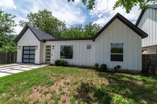 Modern farmhouse style home featuring board and batten siding, a garage, and concrete driveway | Image 5