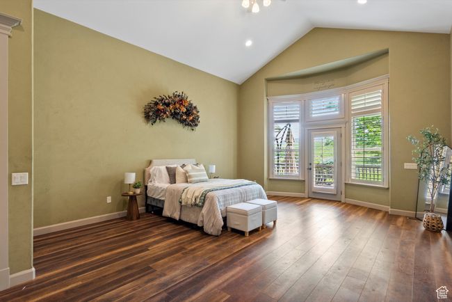 Master Bedroom featuring access to exterior, vaulted ceiling, wood finished floors, baseboards, and recessed lighting | Image 36