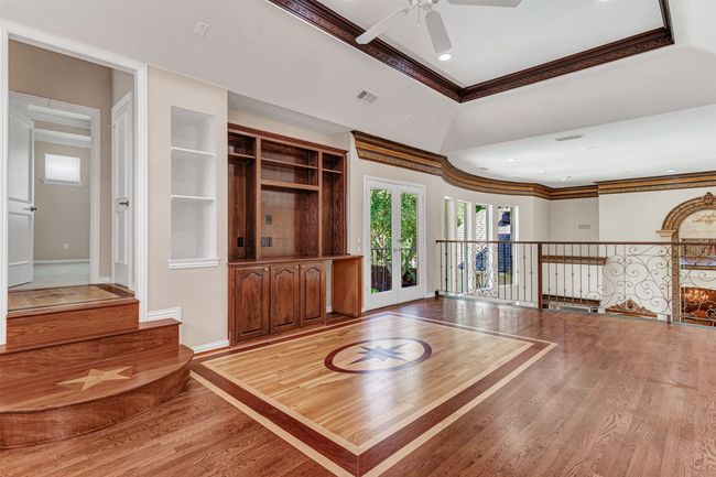 The game room takes the luxury touches a step farther with gorgeous inlay wood design of stars and more! The attention to even the smallest detail is wondrous. | Image 28