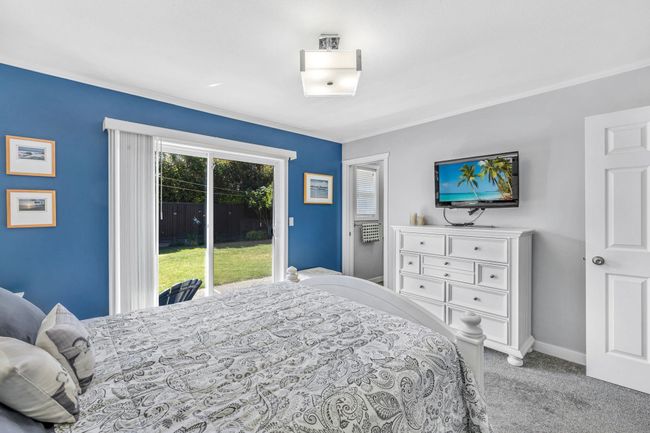 Carpeted bedroom with access to outside, crown molding, and baseboards | Image 19