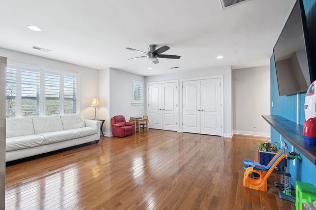Spacious upstairs bonus room with hardwood floors and natural light. | Image 32