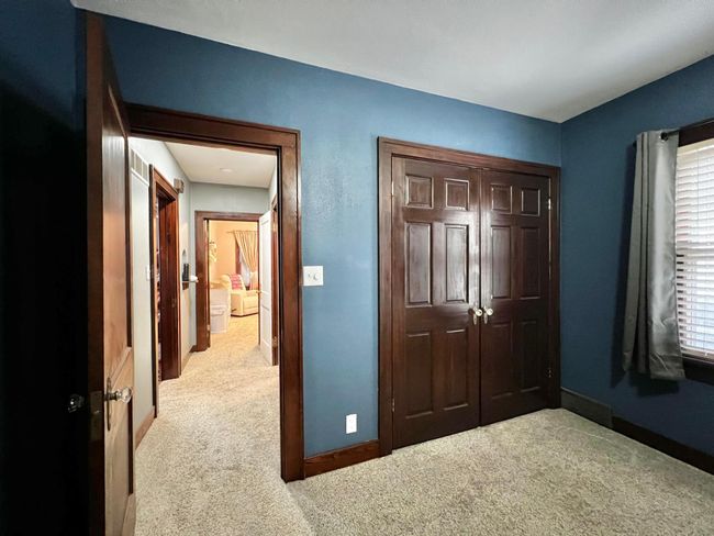 Primary Bedroom Closet & View down the hallway to the Bathroom and 2nd Bedroom | Image 16