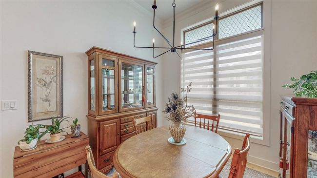 Dining room with a chandelier, crown molding, and a towering ceiling | Image 16