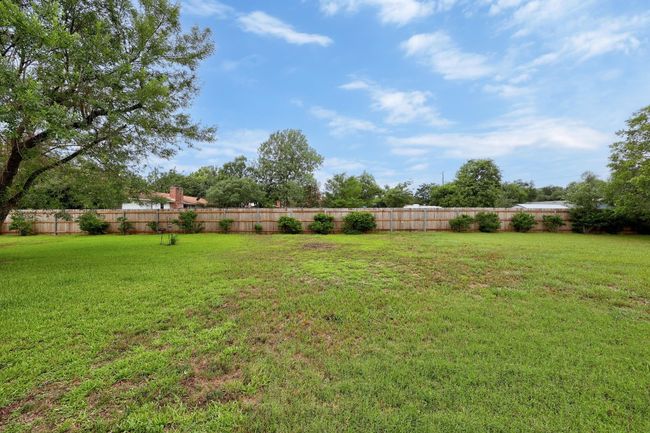 View of fenced backyard | Image 25