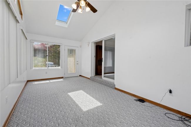 Another View Of The Sunroom Which Includes Skylights And A Ceiling Fan | Image 7