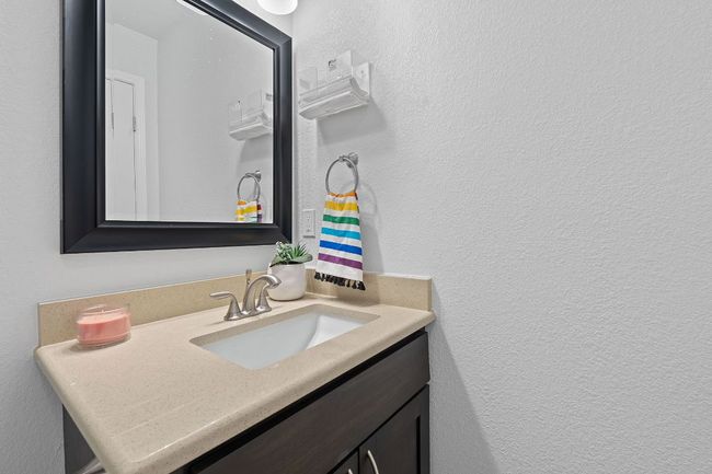 Bathroom featuring vanity and a textured wall | Image 14