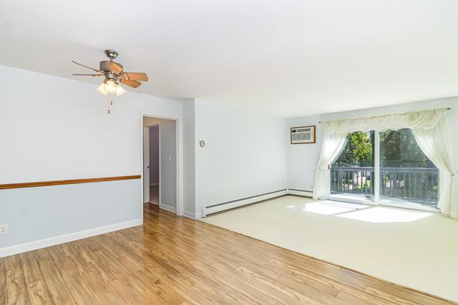 Living room/dining area with a wall-unit air conditioner | Image 4
