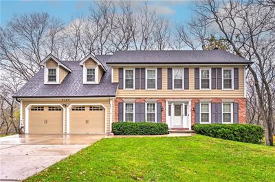 View of front of property with a garage and a front yard | Image 1