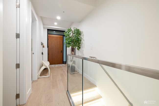 Hallway with light wood-type flooring and recessed lighting | Image 18