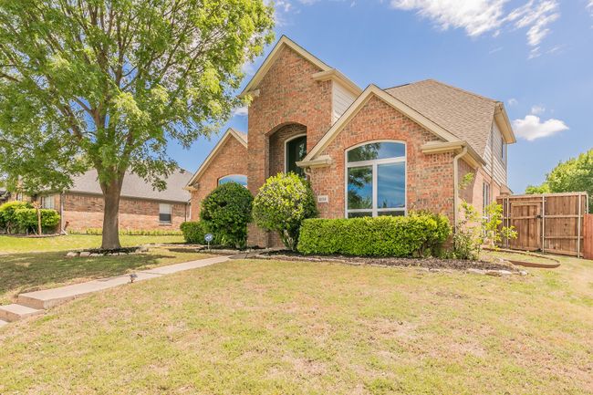 View of front of property featuring a gate, fence, a shingled roof, brick siding, and a front yard | Image 4